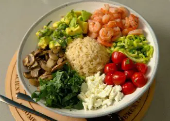 a plate of food with shrimp, rice, and vegetables