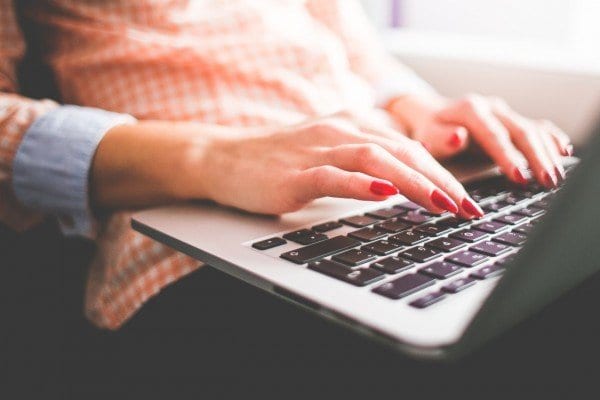 questions-600×400-1 girl with acne typing on laptop